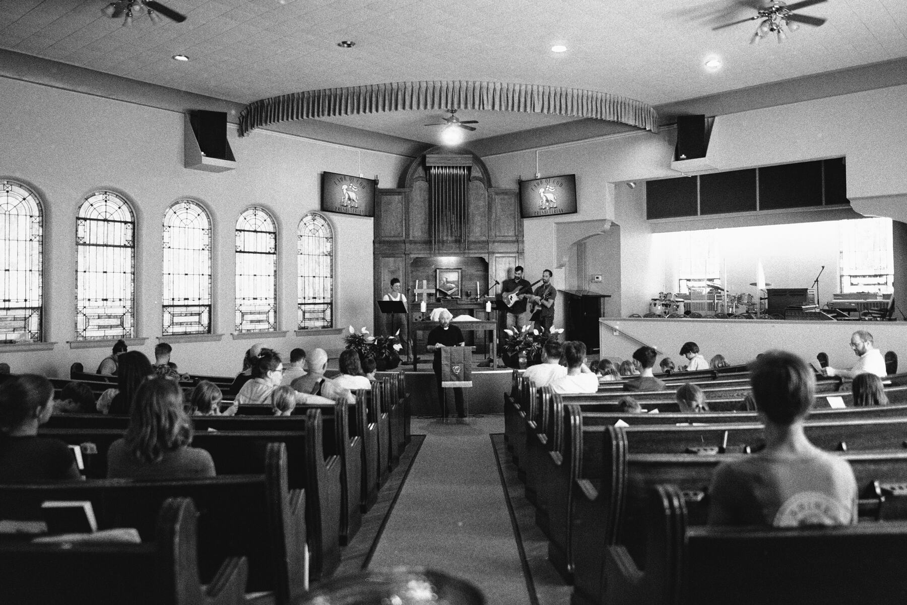 The congregation seated in the pews during the service.