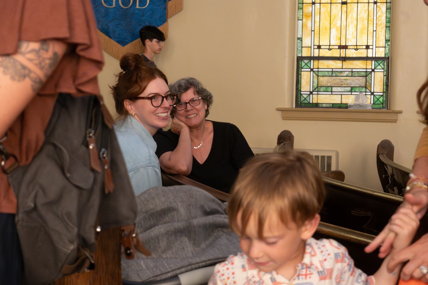 Members of the congregation talking and laughing together after the service.
